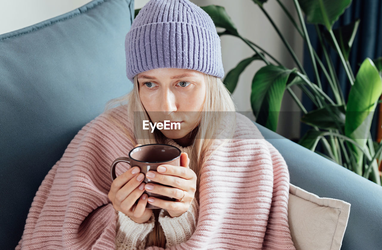 portrait of woman holding coffee cup