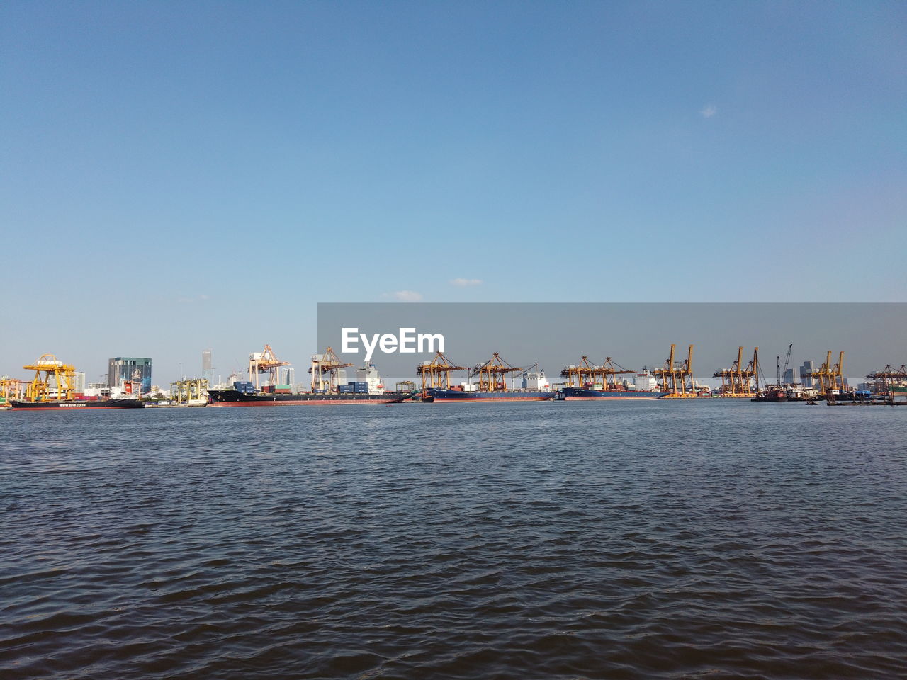 SEA BY PIER AGAINST SKY