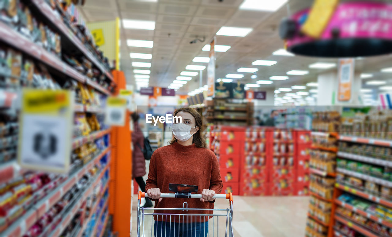 Woman wearing mask shopping at mall