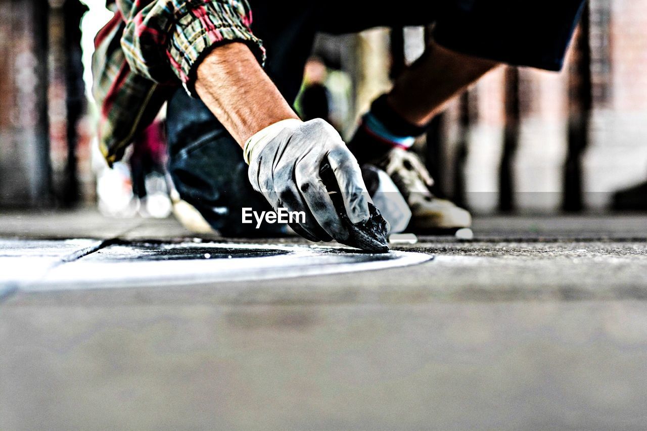 Low section of manual worker repairing street