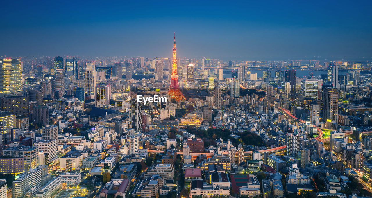 Tokyo tower against sky in city at night