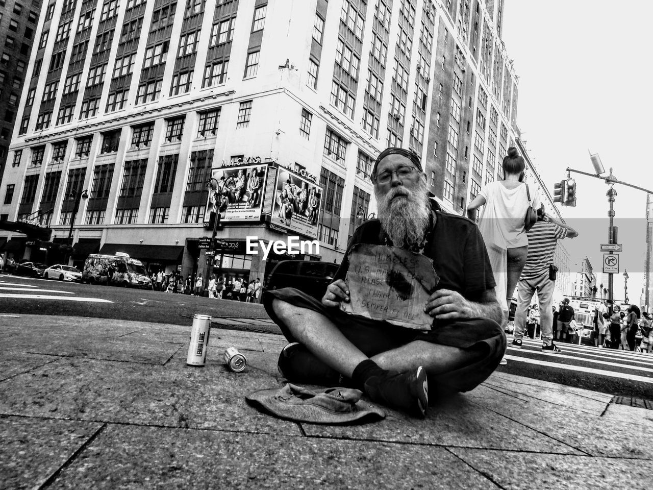 architecture, city, road, building exterior, street, built structure, black and white, sitting, men, full length, adult, city life, monochrome, monochrome photography, lifestyles, one person, leisure activity, day, casual clothing, infrastructure, black, building, city street, young adult, outdoors, person, nature, footpath, relaxation