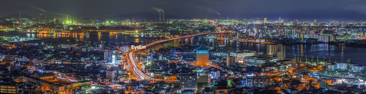 High angle view of city lit up at night