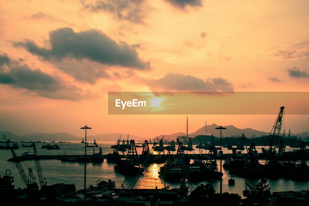 View of harbor against sky during sunset