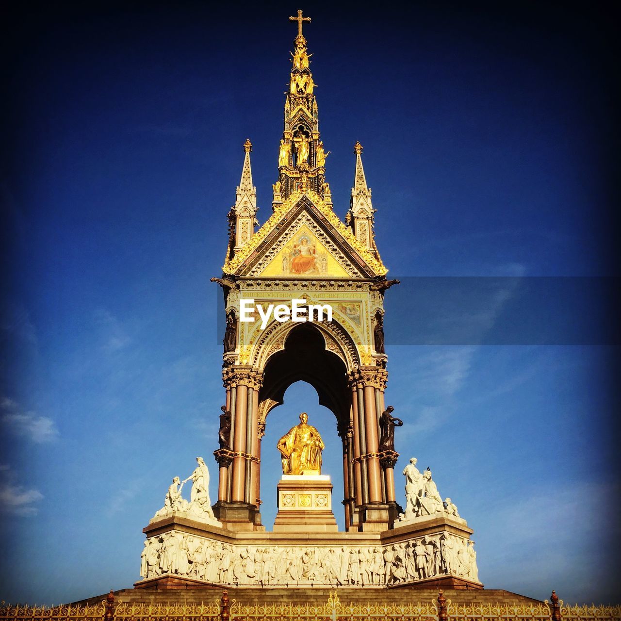 Low angle view of statues against blue sky