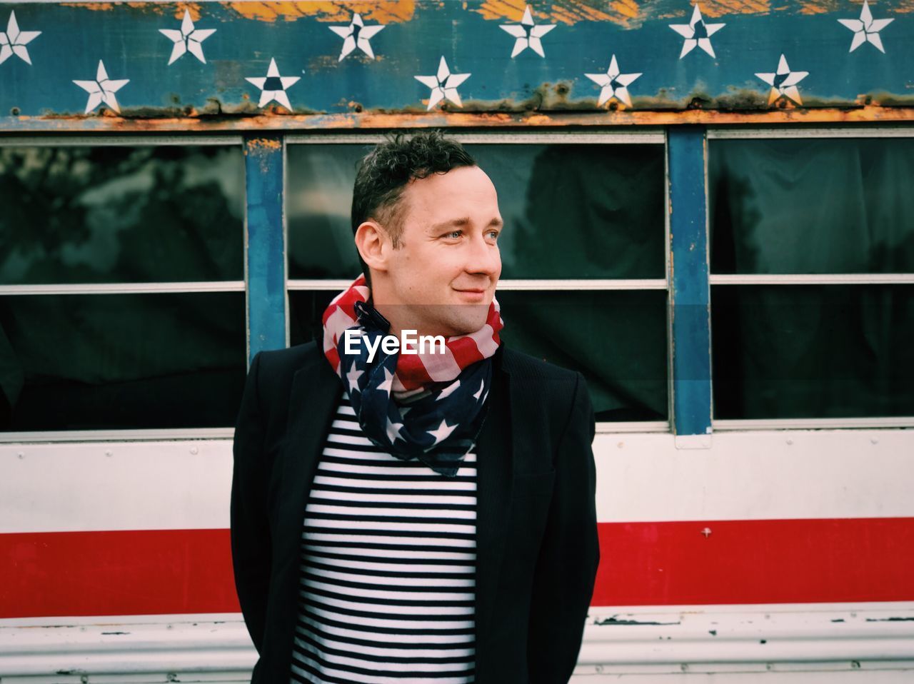 Portrait of man wearing american flag as scarf