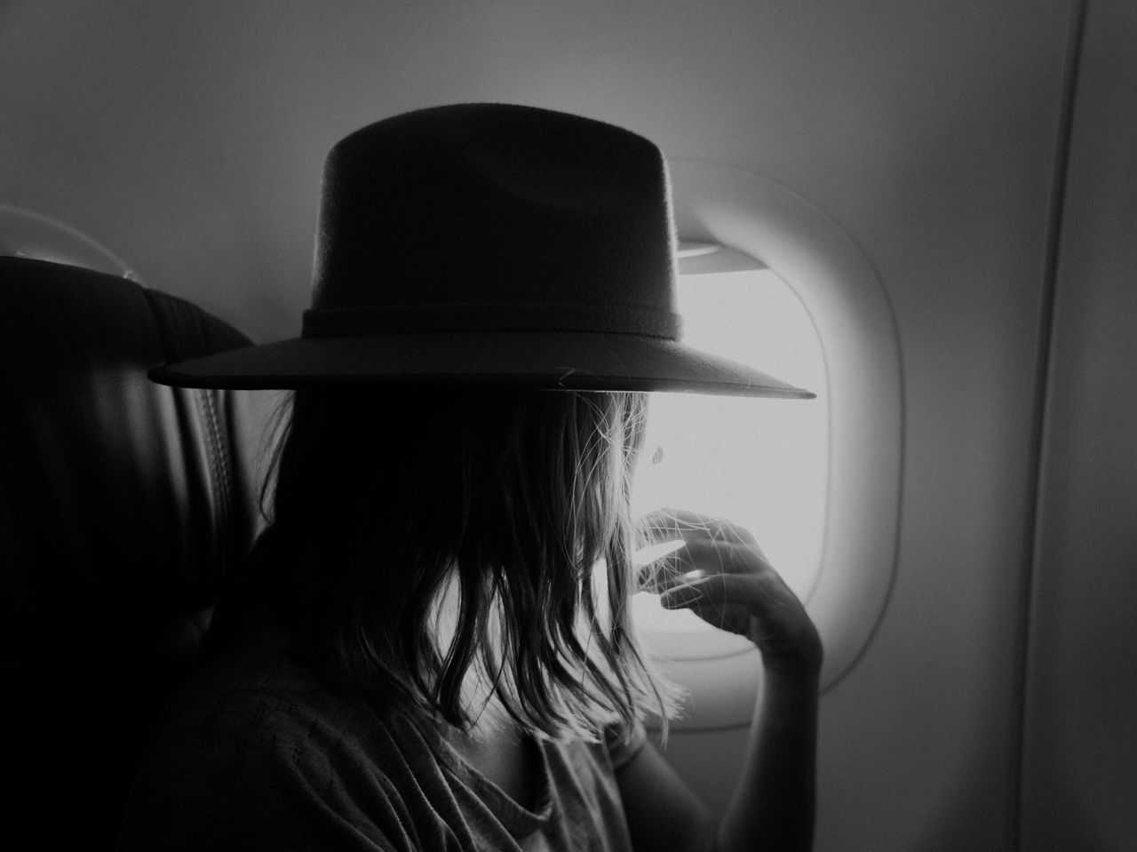 Woman wearing hat in the airplane 