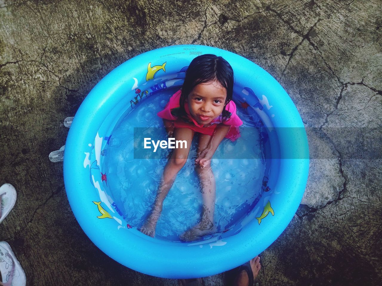 Girl playing water in a small pond