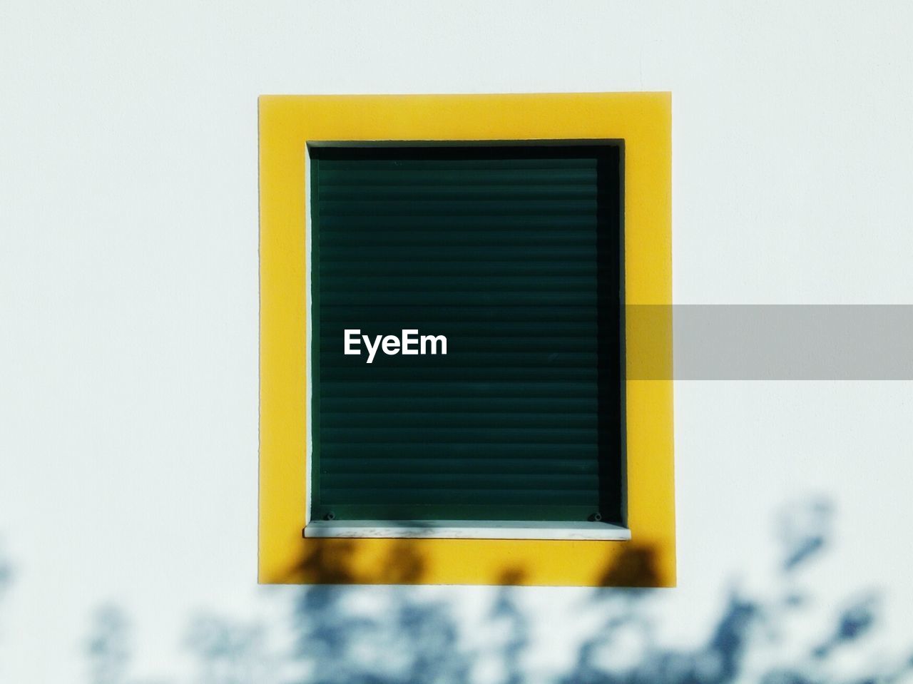 Close-up of yellow window against clear sky