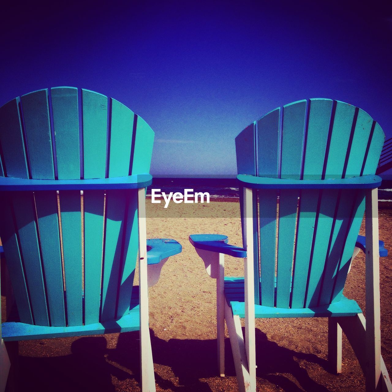 EMPTY CHAIRS AT SEASIDE