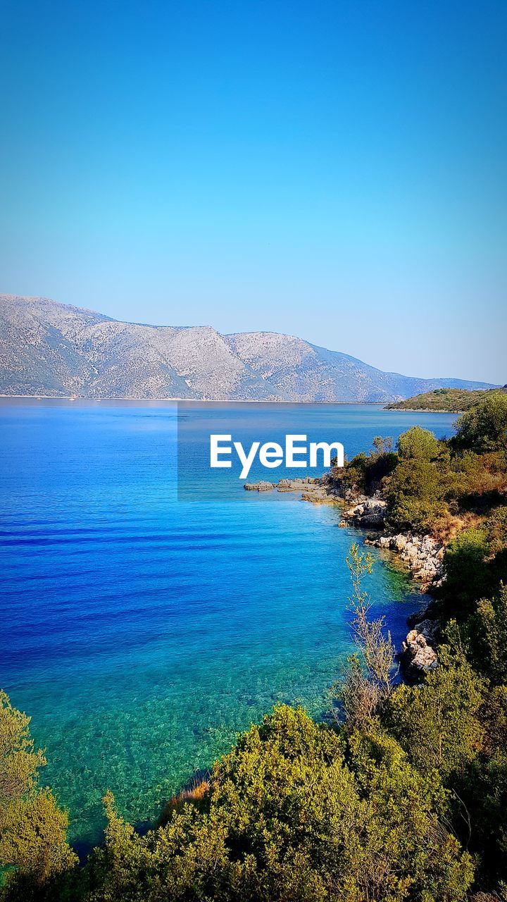 Scenic view of sea against clear blue sky