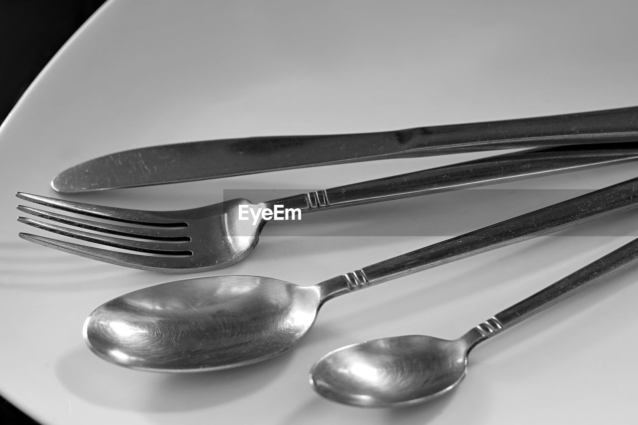 CLOSE-UP OF SPOON AND WHITE BACKGROUND