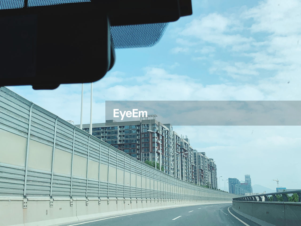 ROAD BY BUILDINGS AGAINST SKY