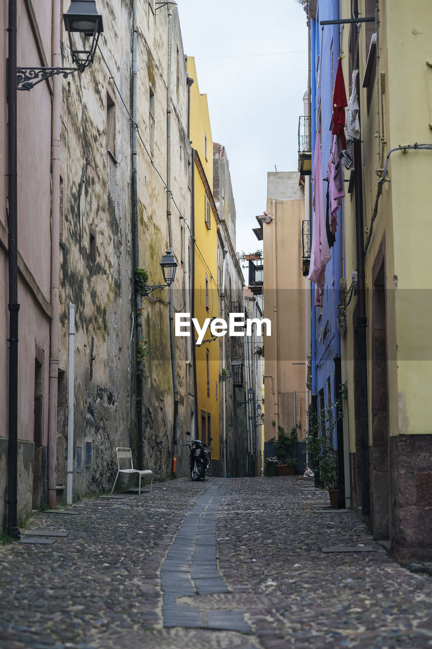 Low angle view of narrow alley along buildings