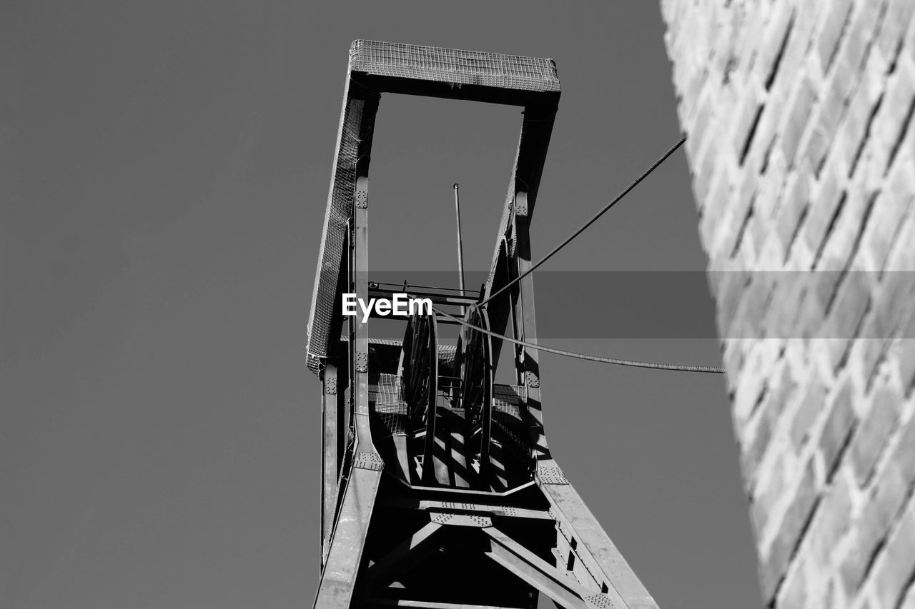 Low angle view of crane against clear sky