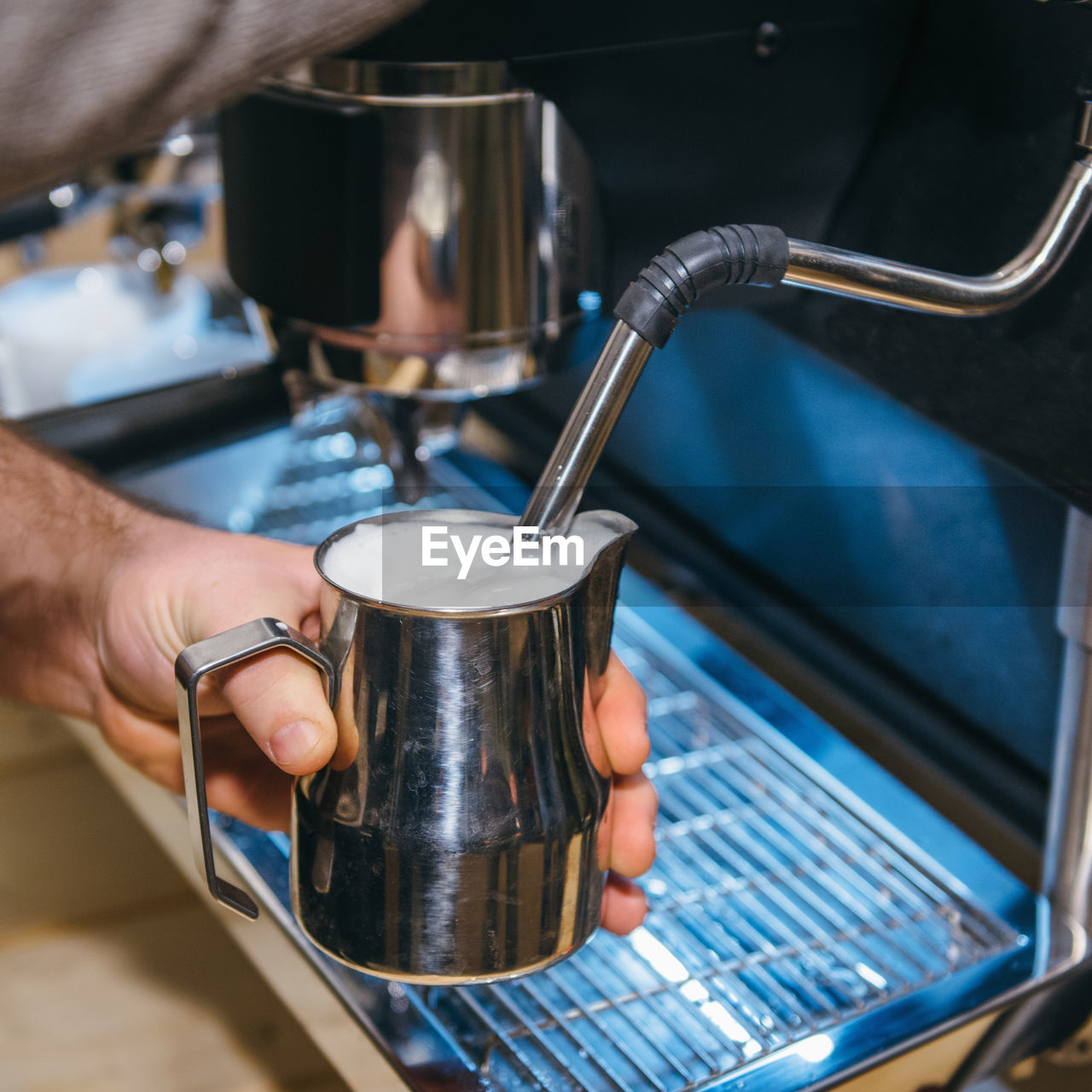 Cropped hand making coffee