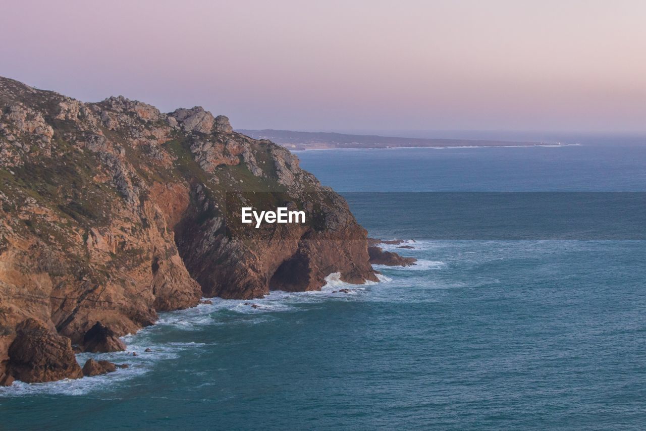 Scenic view of sea and rock formation against sky