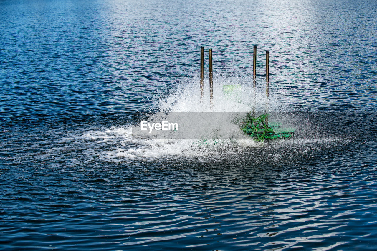 Paddle wheels aerators in lake, waste water treatment by fill oxygen into water.