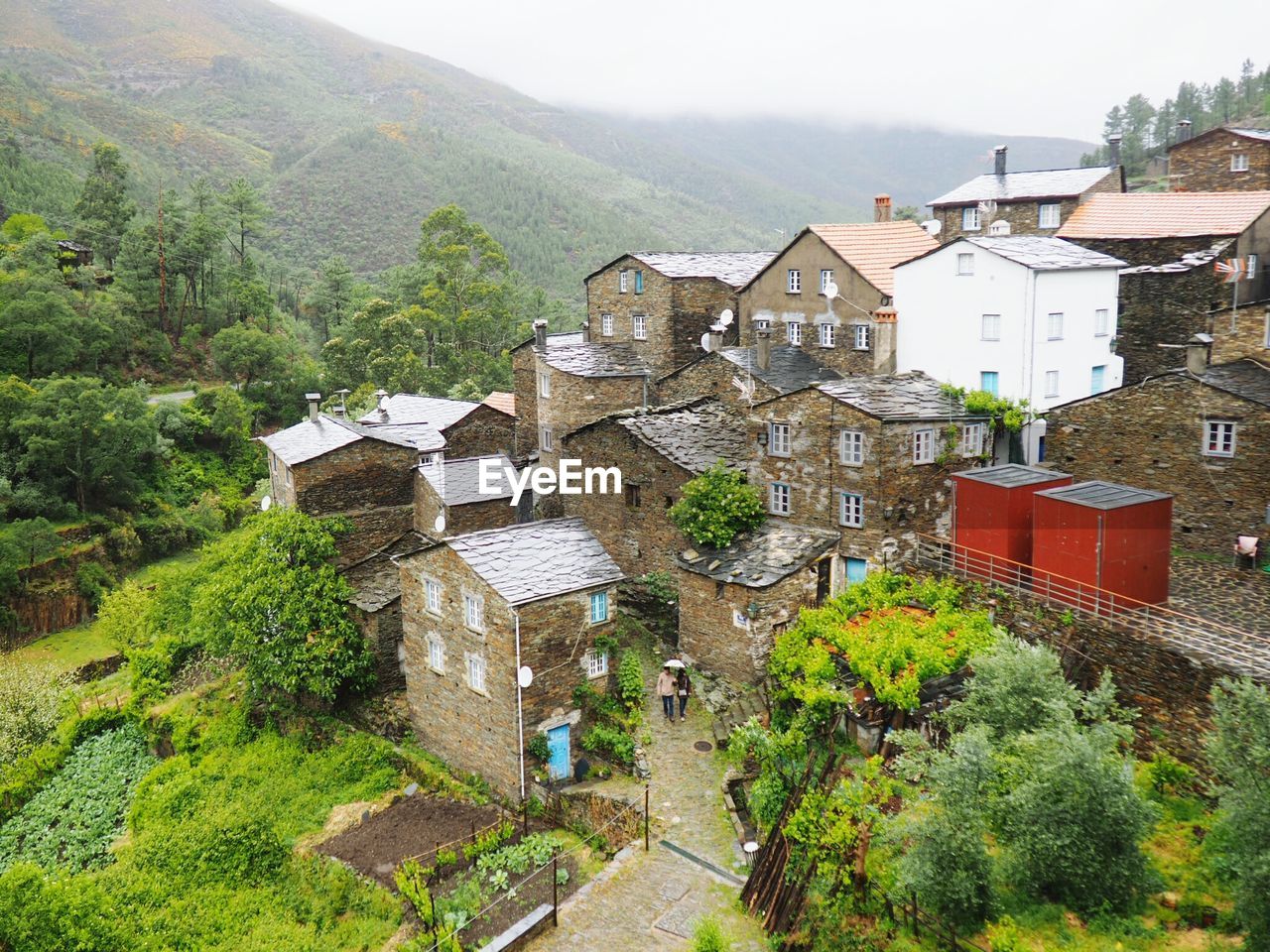 High angle view of houses and trees against sky