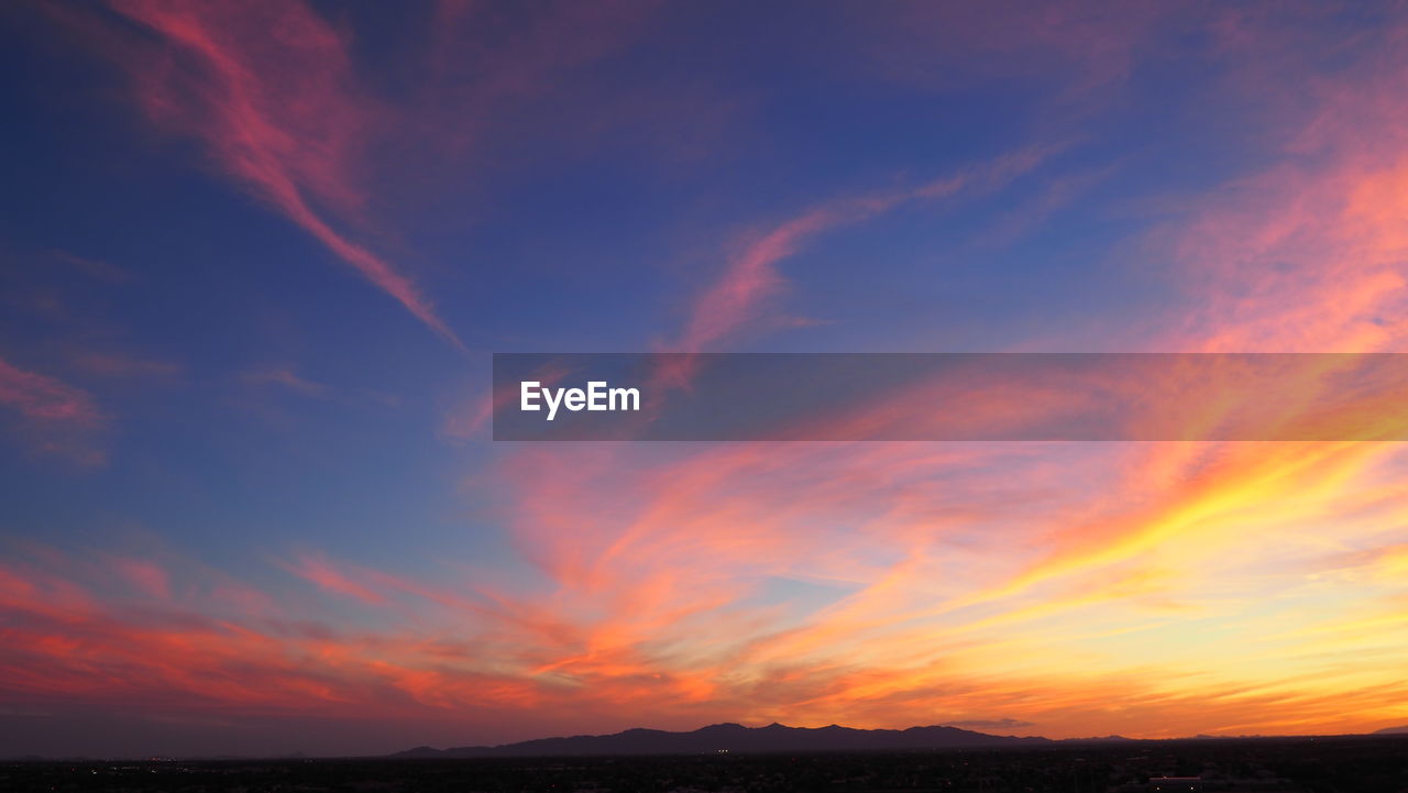 Low angle view of dramatic sky during sunset