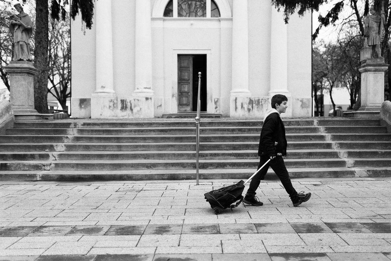 WOMAN WALKING ON CITY STREET