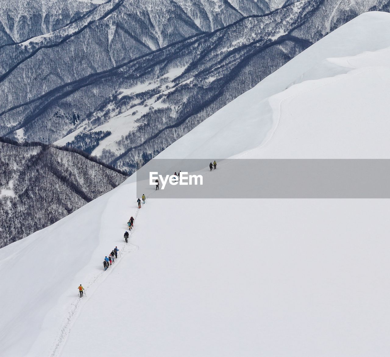 High angle view of people walking on snow covered land