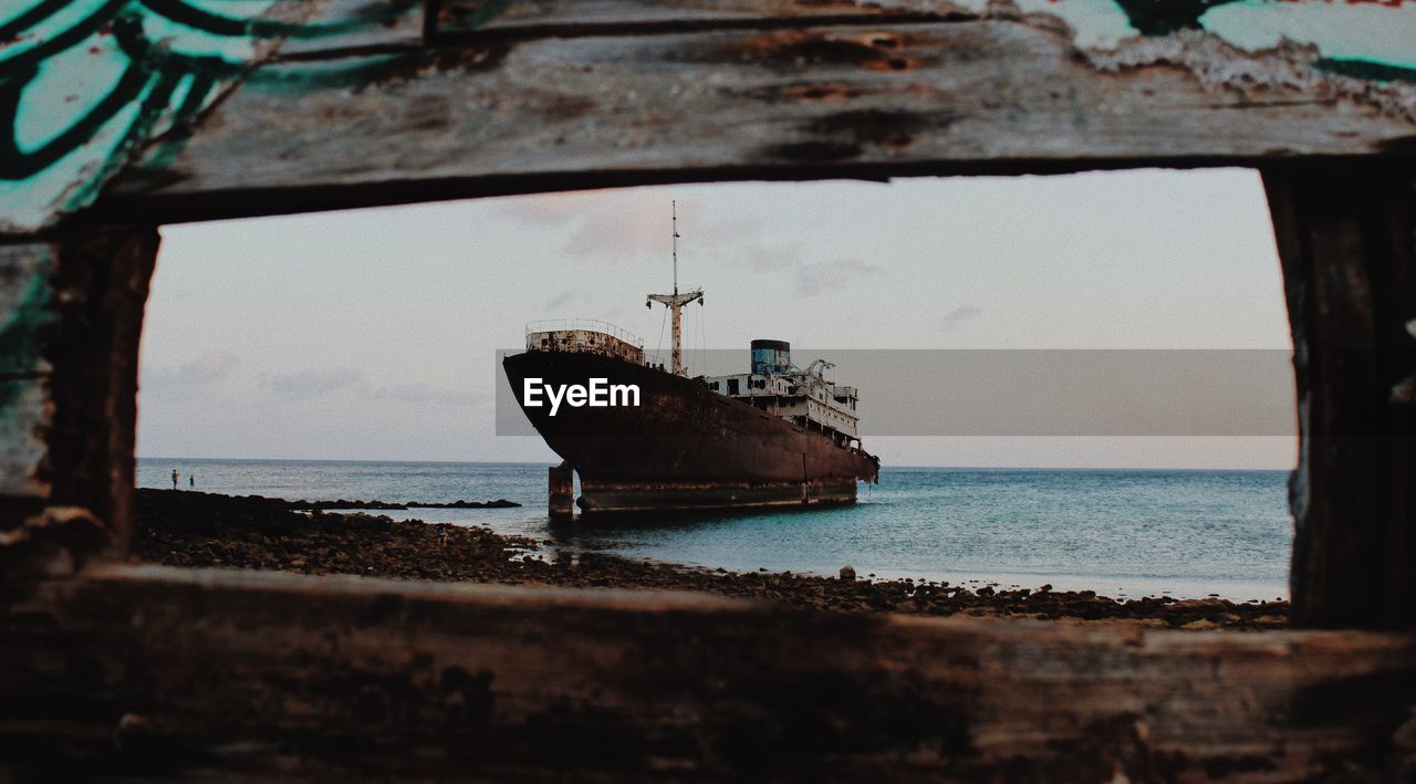 Abandoned ship at sea against sky