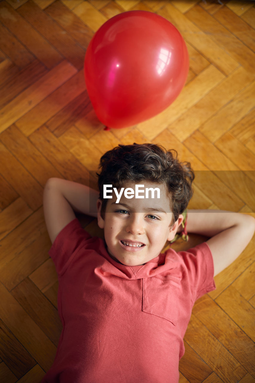 Loving moment of happy boy with his ballon