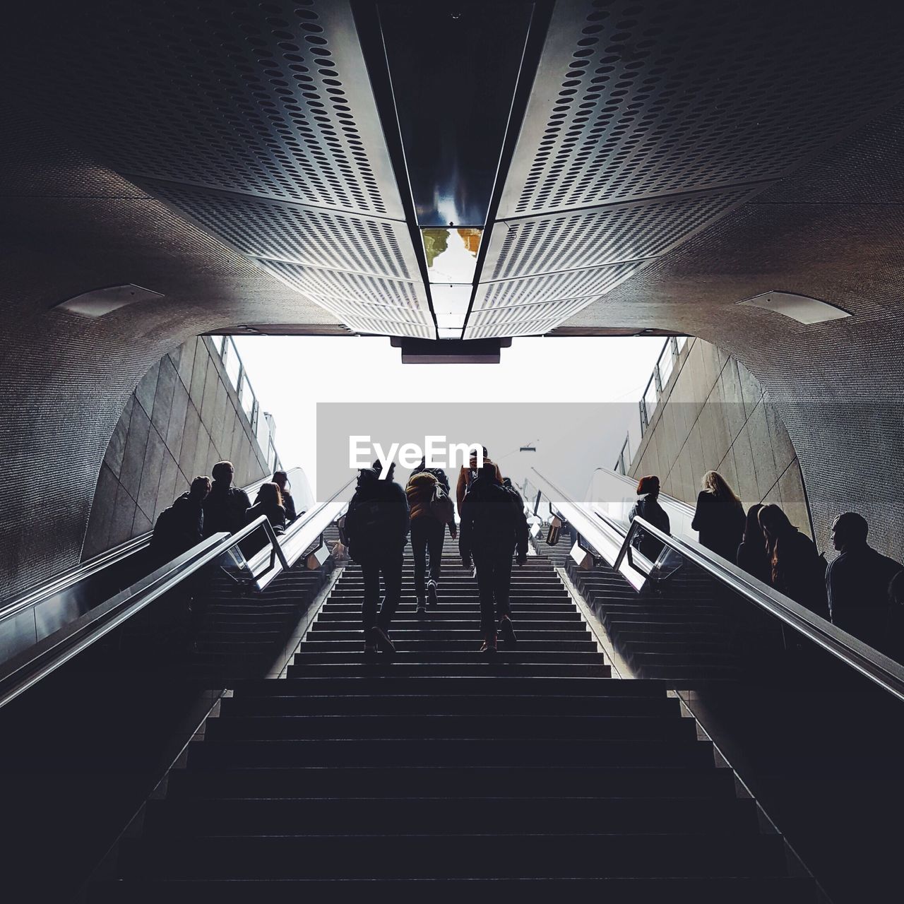 Low angle view of people walking up stairs