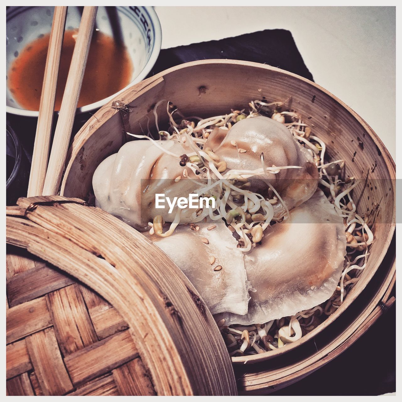 Close-up of chinese dumplings with chopsticks