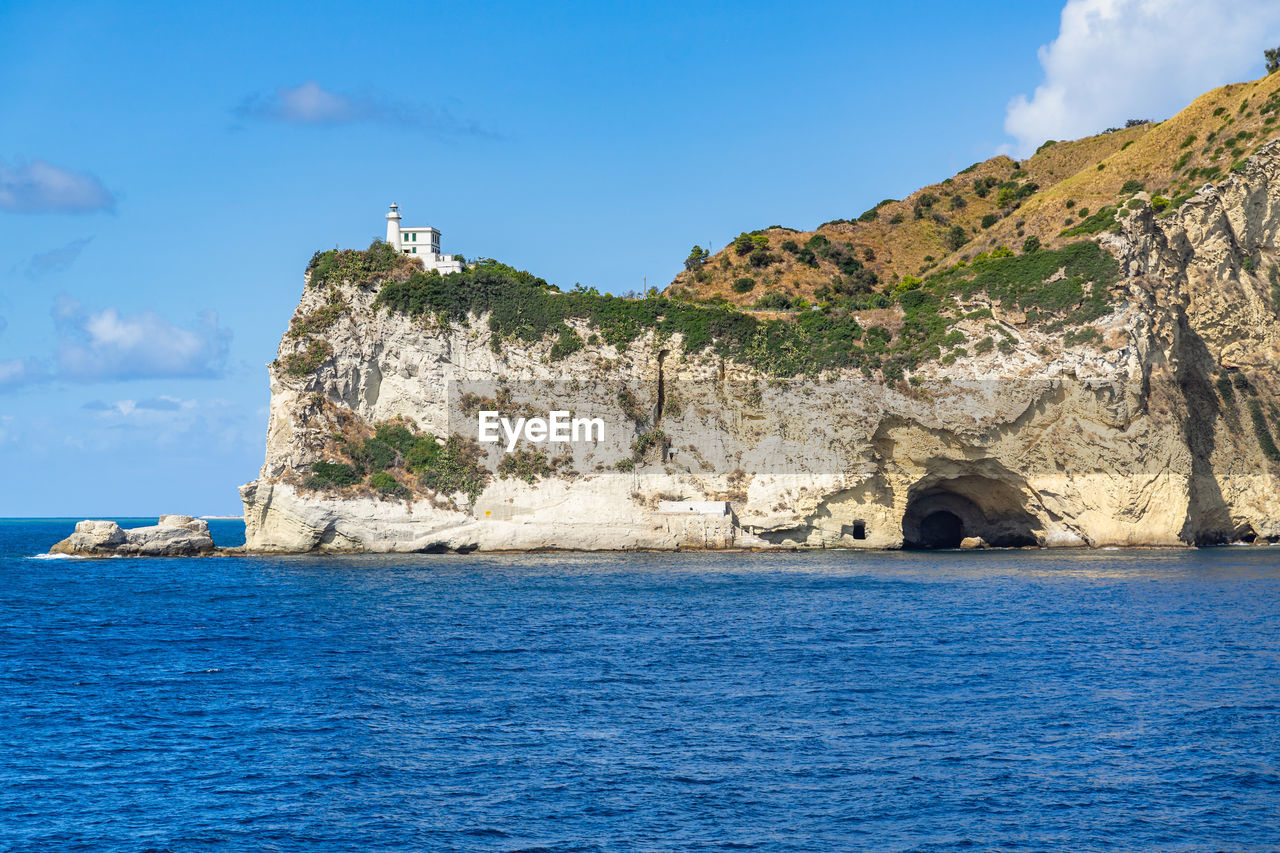 Scenic view of capo miseno and its lighthouse that marks the limit of the gulf of naples, italy