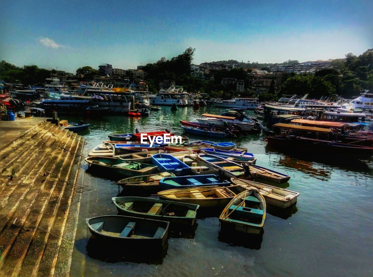 BOATS MOORED AT WATERFRONT