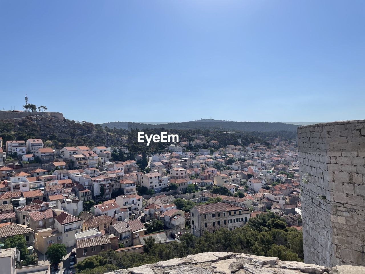 architecture, built structure, building exterior, town, city, building, cityscape, sky, nature, residential district, ancient history, travel destinations, no people, clear sky, history, high angle view, house, travel, the past, outdoors, mountain, blue, land, landmark, tourism, day, environment, community, copy space, landscape, roof, aerial photography, old