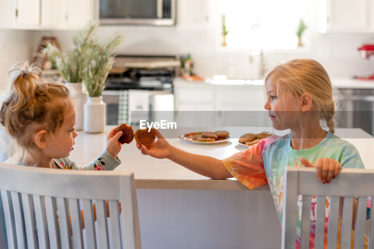 Women holding food in kitchen