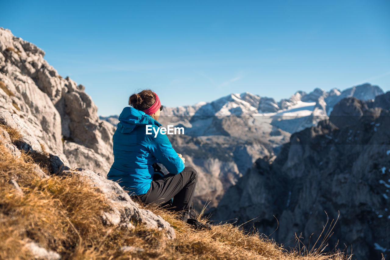 Woman enjoying the view at alpine landscape in autumn, bischofsmütze, annaberg, austria