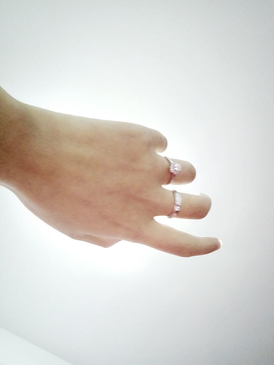 CLOSE-UP OF WOMAN HAND ON WHITE BACKGROUND