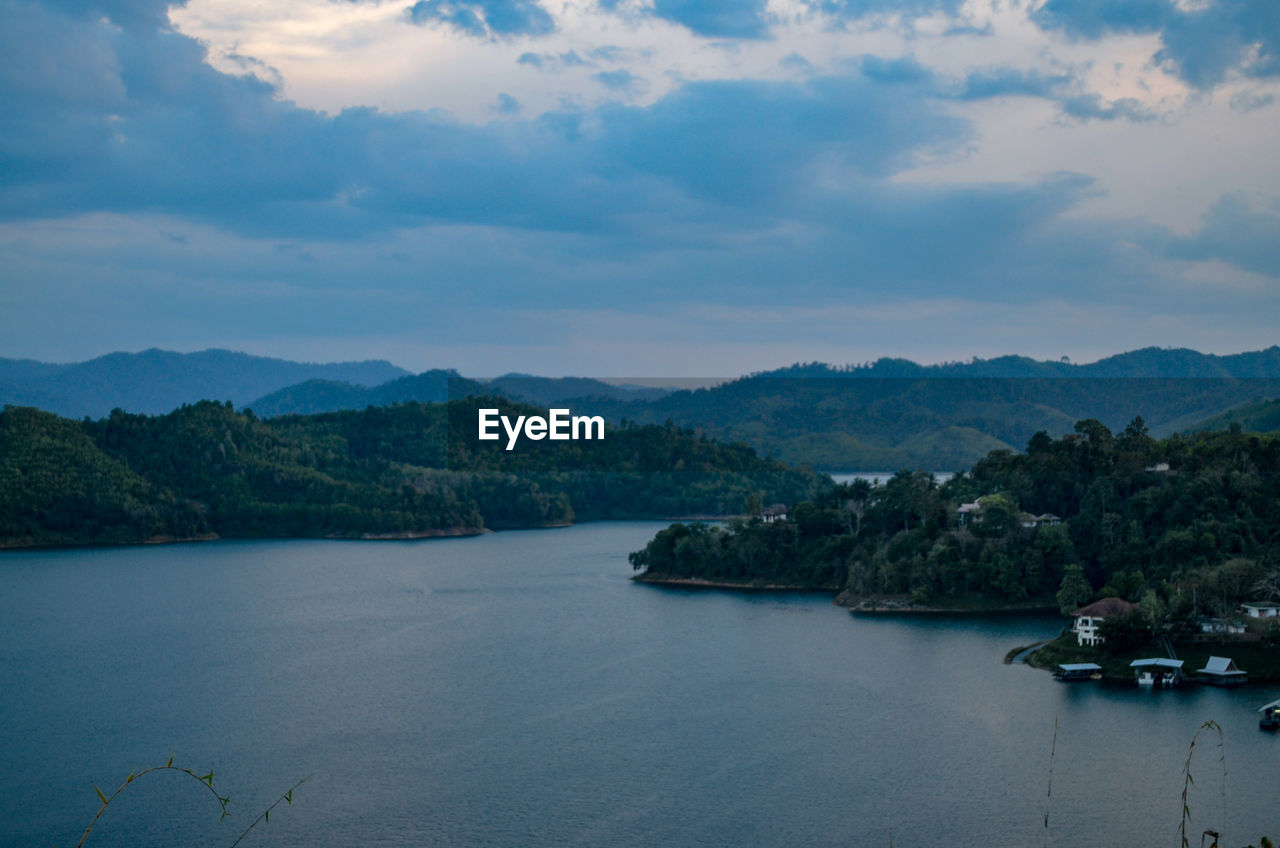 Scenic view of sea and mountains against sky