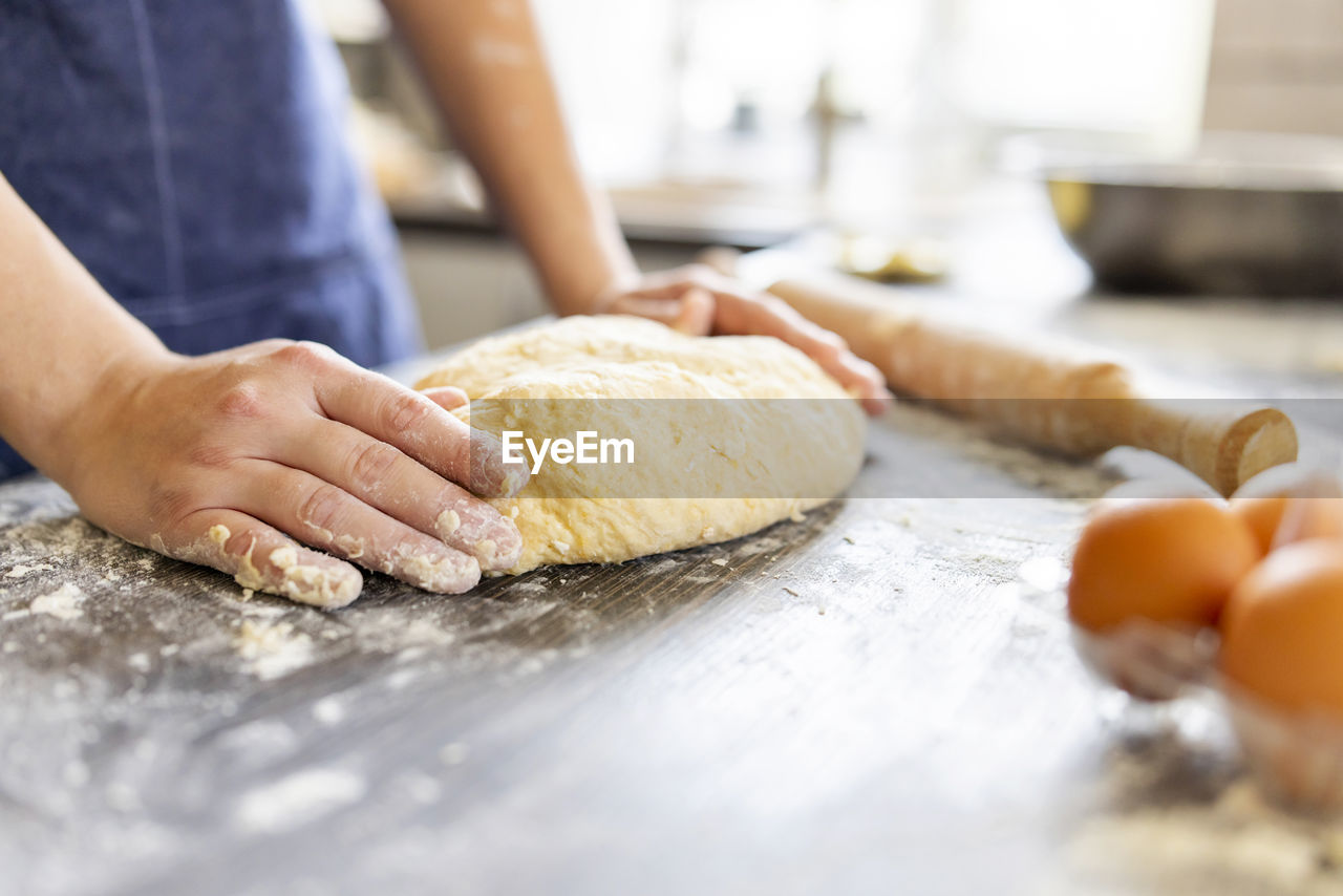 midsection of person preparing food on table