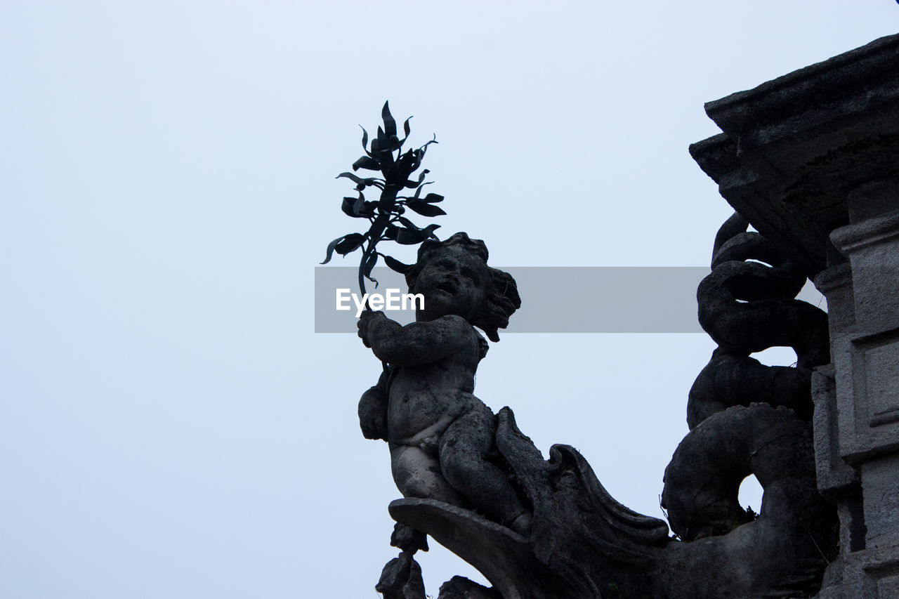 LOW ANGLE VIEW OF STATUES AGAINST SKY