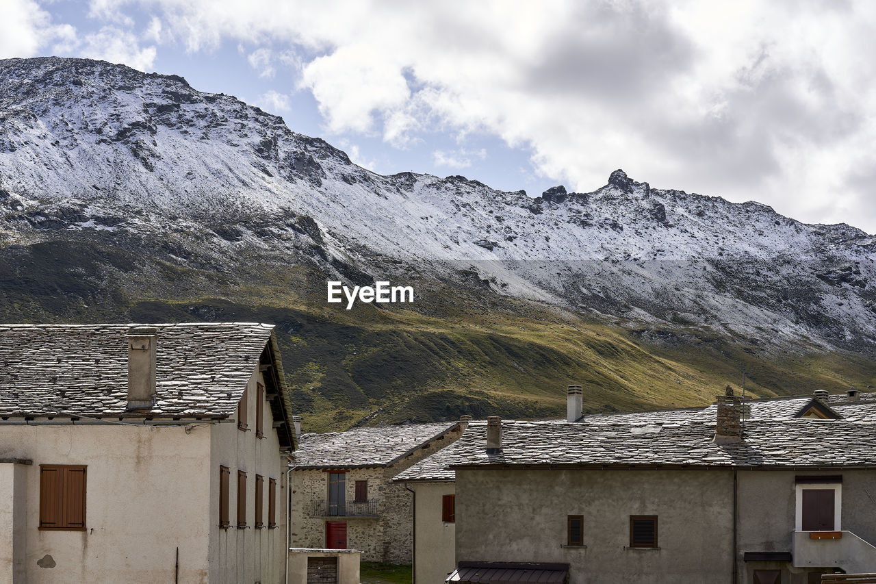 Houses against mountains during winter
