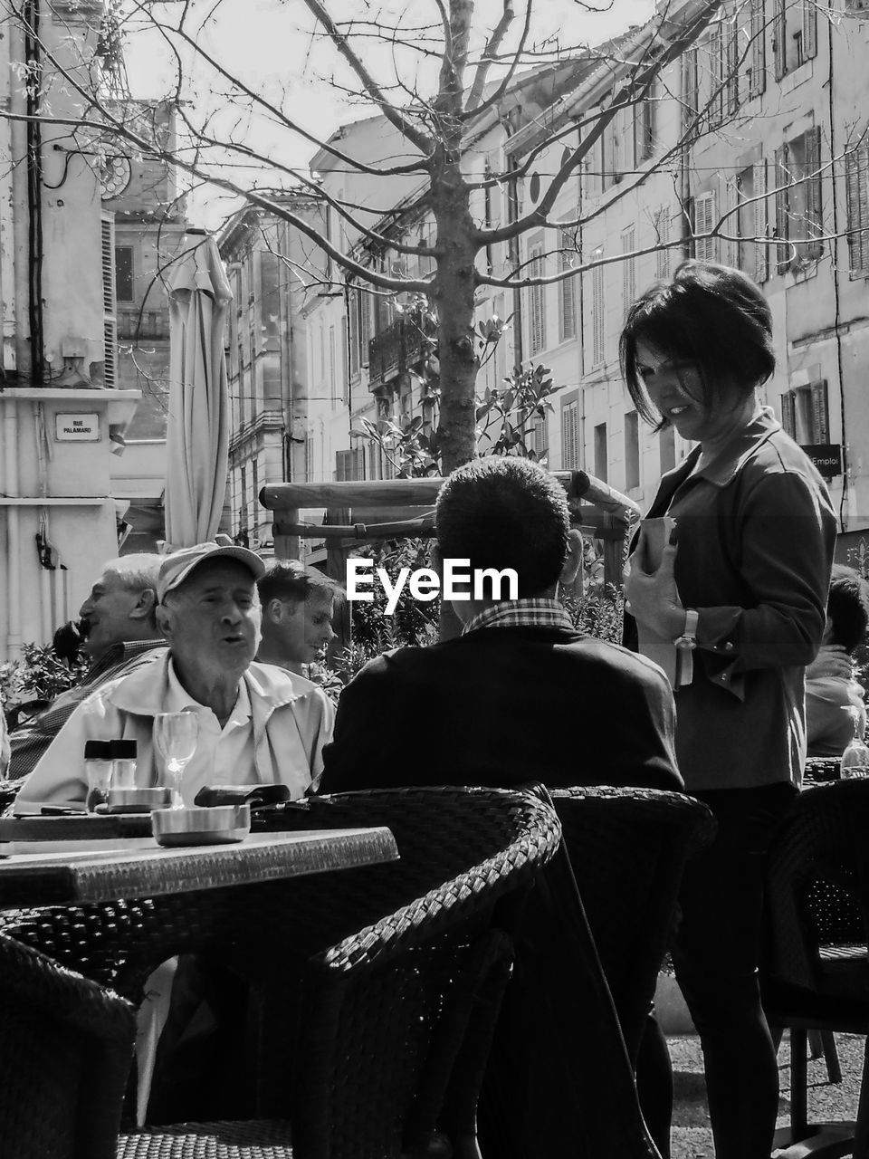 PEOPLE SITTING IN TOWN SQUARE