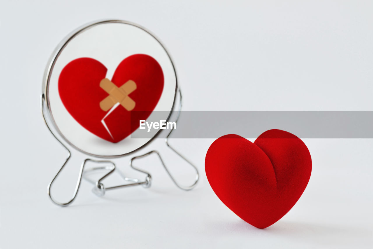 Broken heart looking in the mirror - concept of love and pain