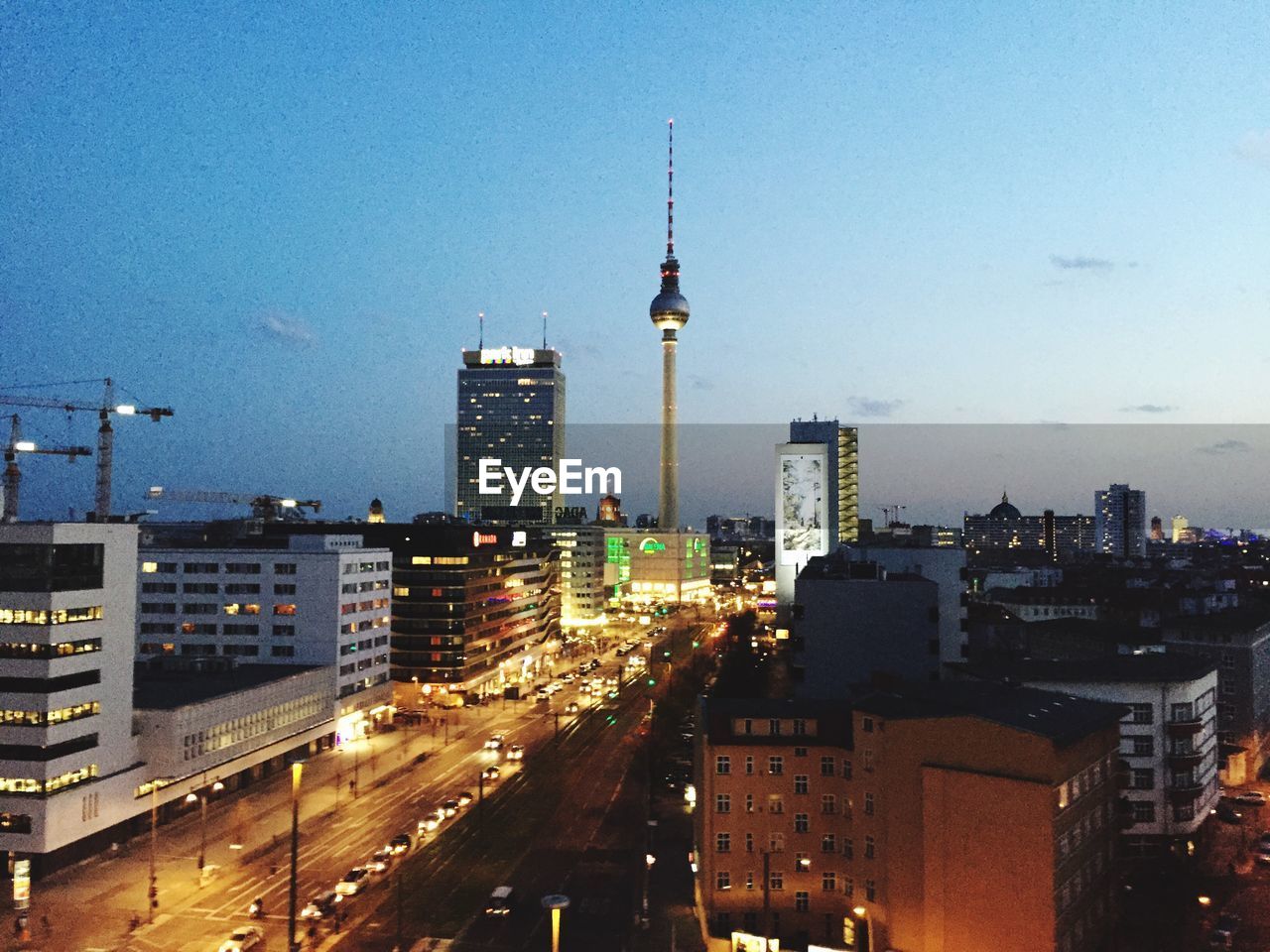 Elevated view of cityscape with illuminated road at dusk