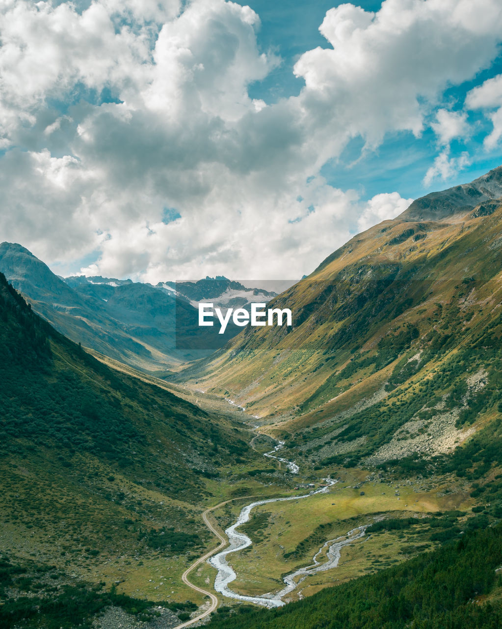 Scenic view of valley and mountains against sky