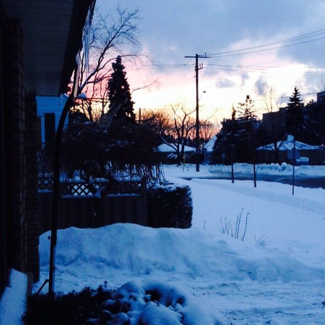 SNOW COVERED LANDSCAPE AT SUNSET