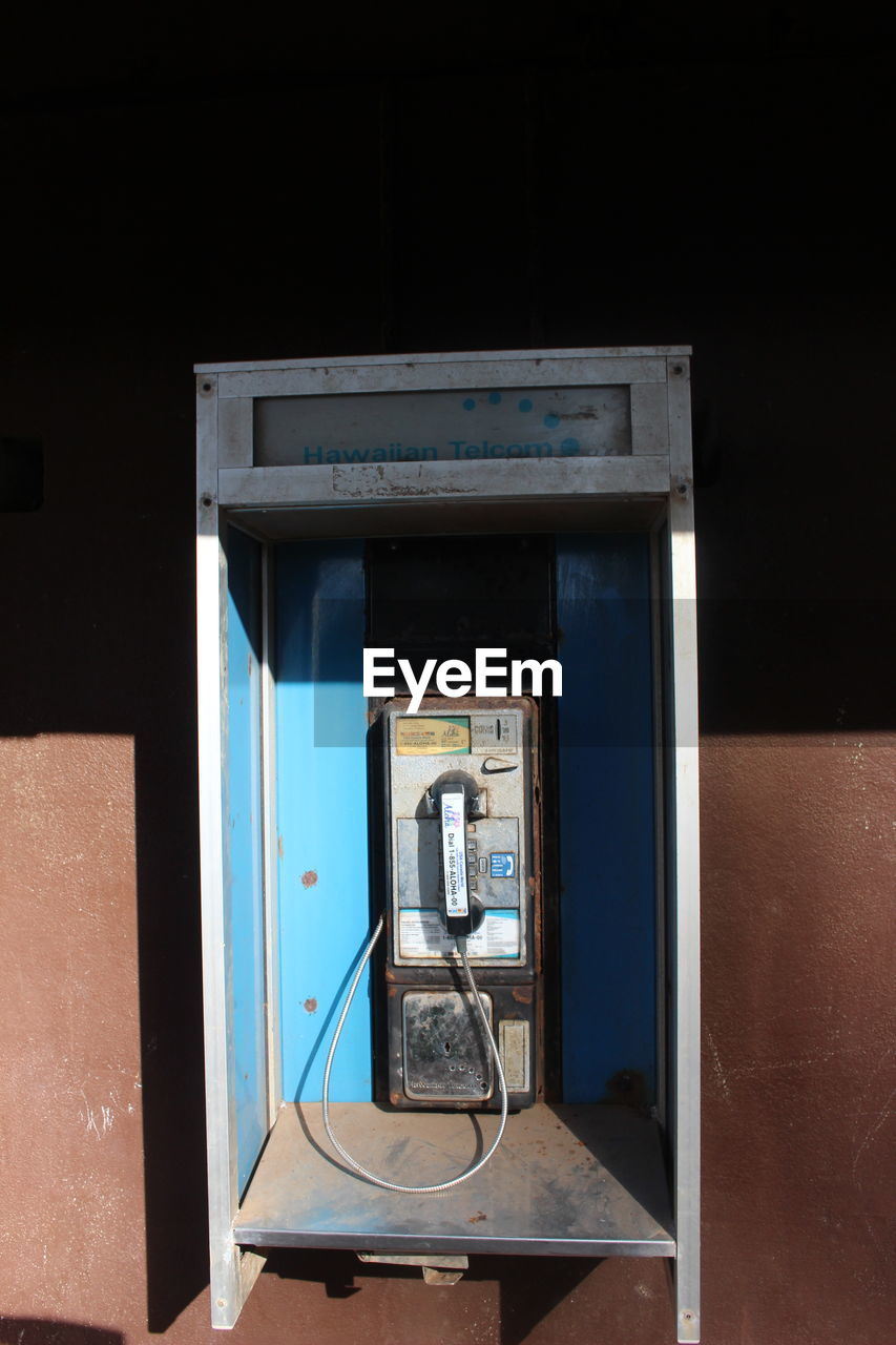 Telephone booth against wall