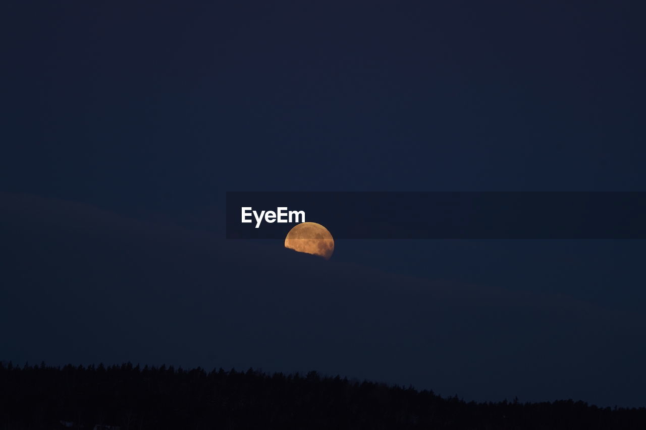 Low angle view of moon against sky at night