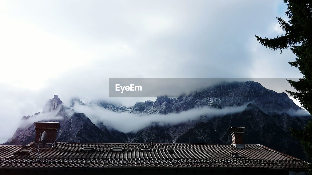 House roof against sky during winter