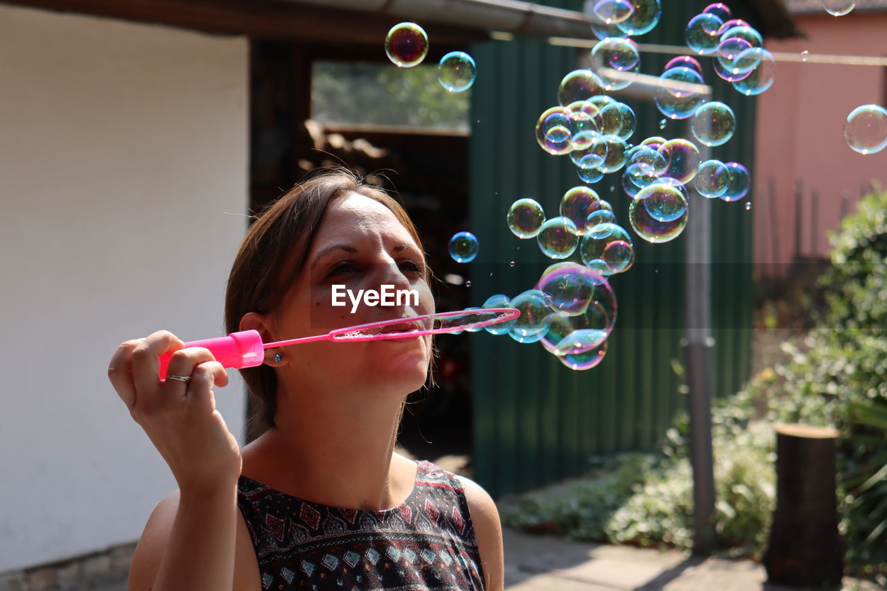 Full length of girl holding bubbles