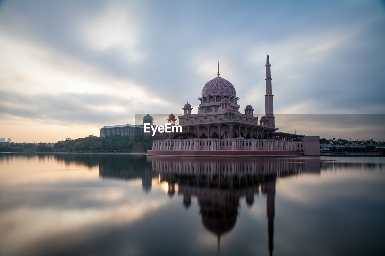 Reflection of temple in lake against sky